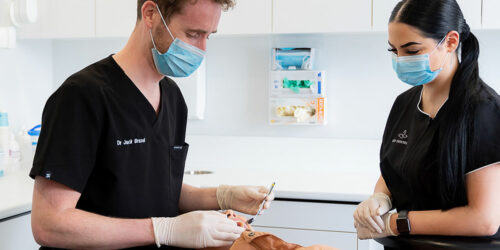 dentist working on patient in chair