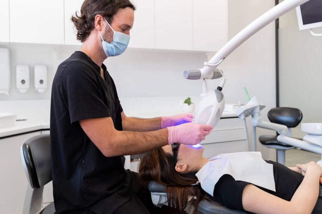 Dentist doing professional teeth whitening