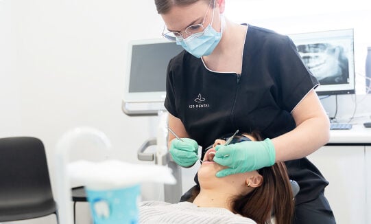 Dentist performing a general checkup at 123 Dental