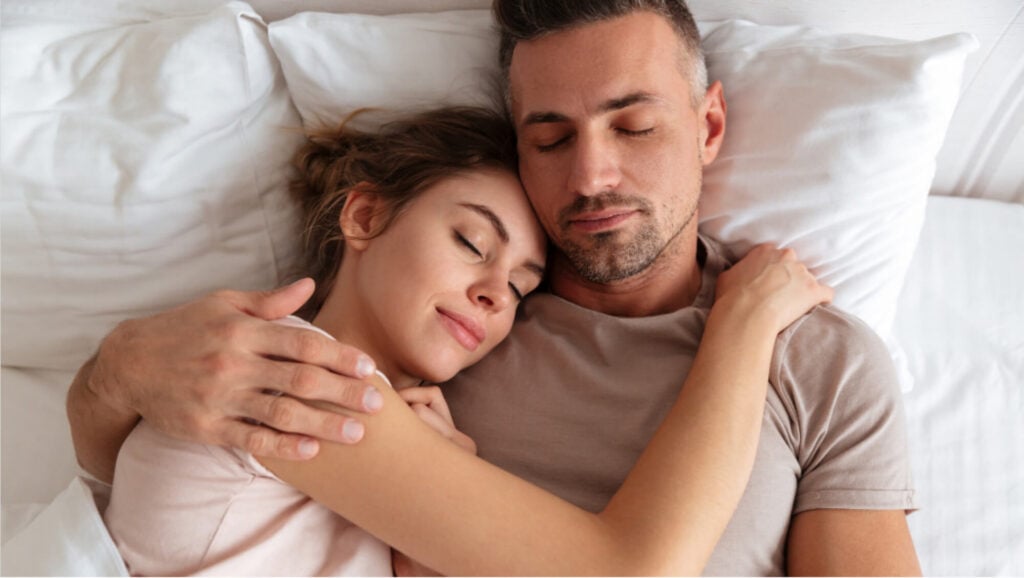 Couple embracing in bed