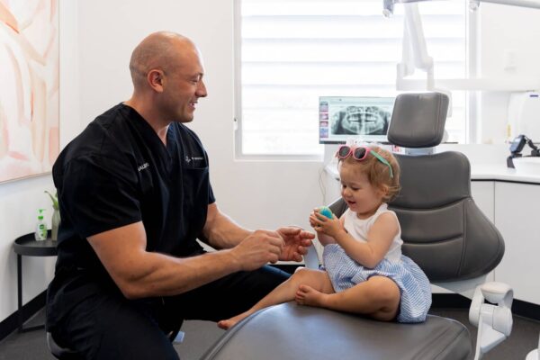 child sitting on dental seat