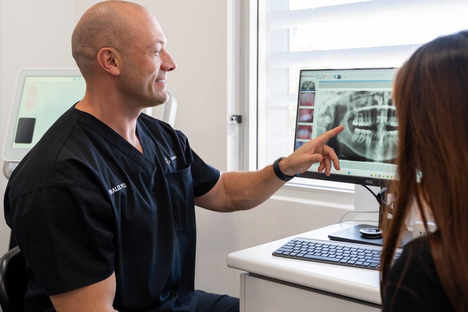 Dentist pointing at dental x ray