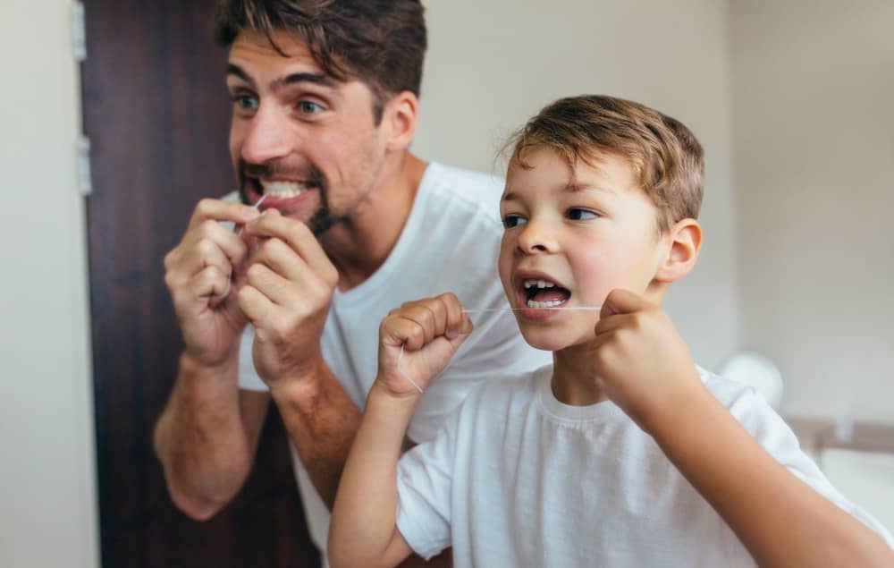 Flossing reduces the build-up of food particles and plaque from between the teeth.