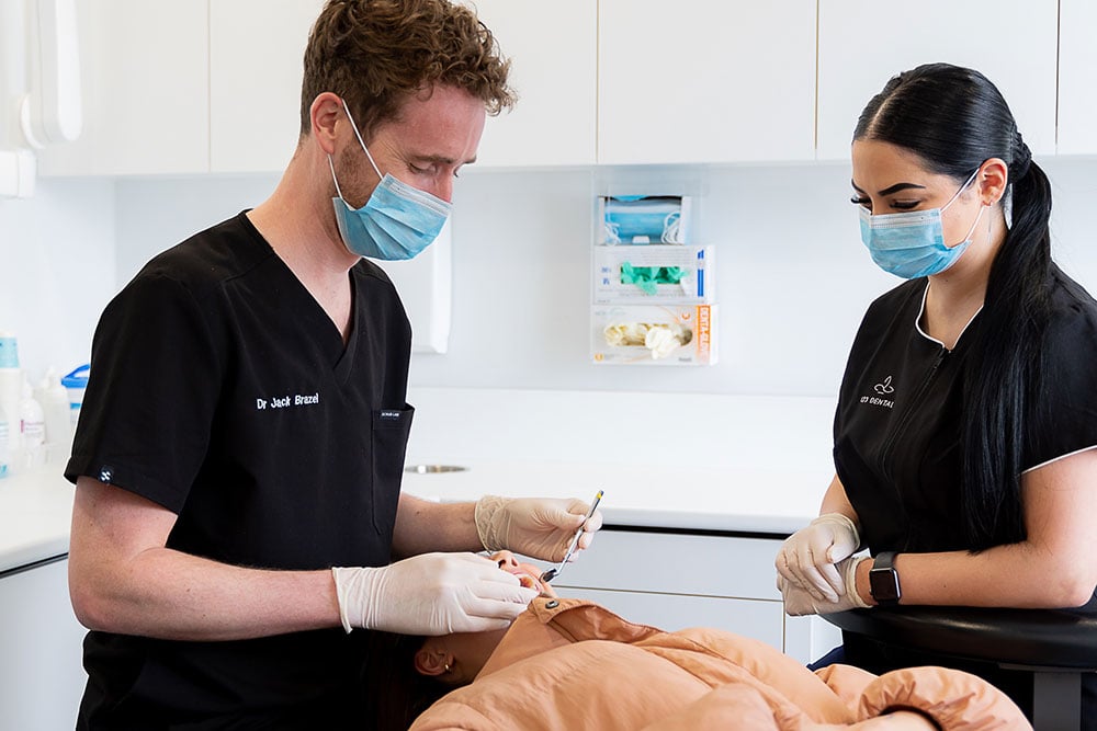 Dentist working on patient in chair