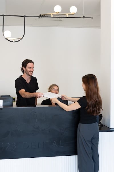 patient filling out form for 123 dental