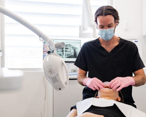 Dentist preparing a patient for teeth whitening
