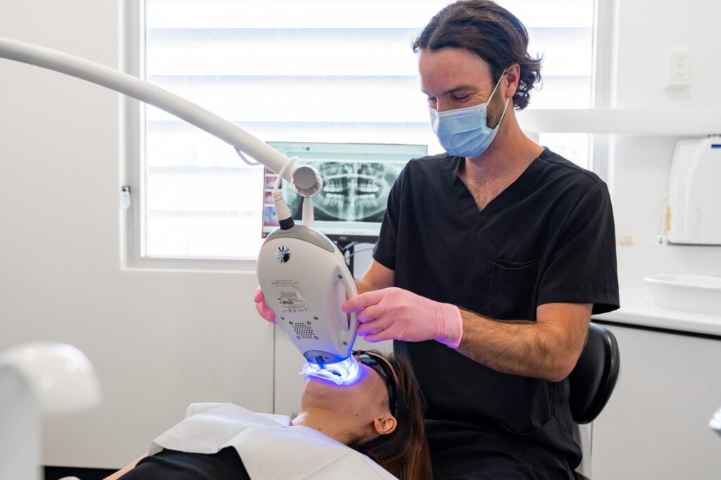 Teeth whitening process with bleach fluoride machine